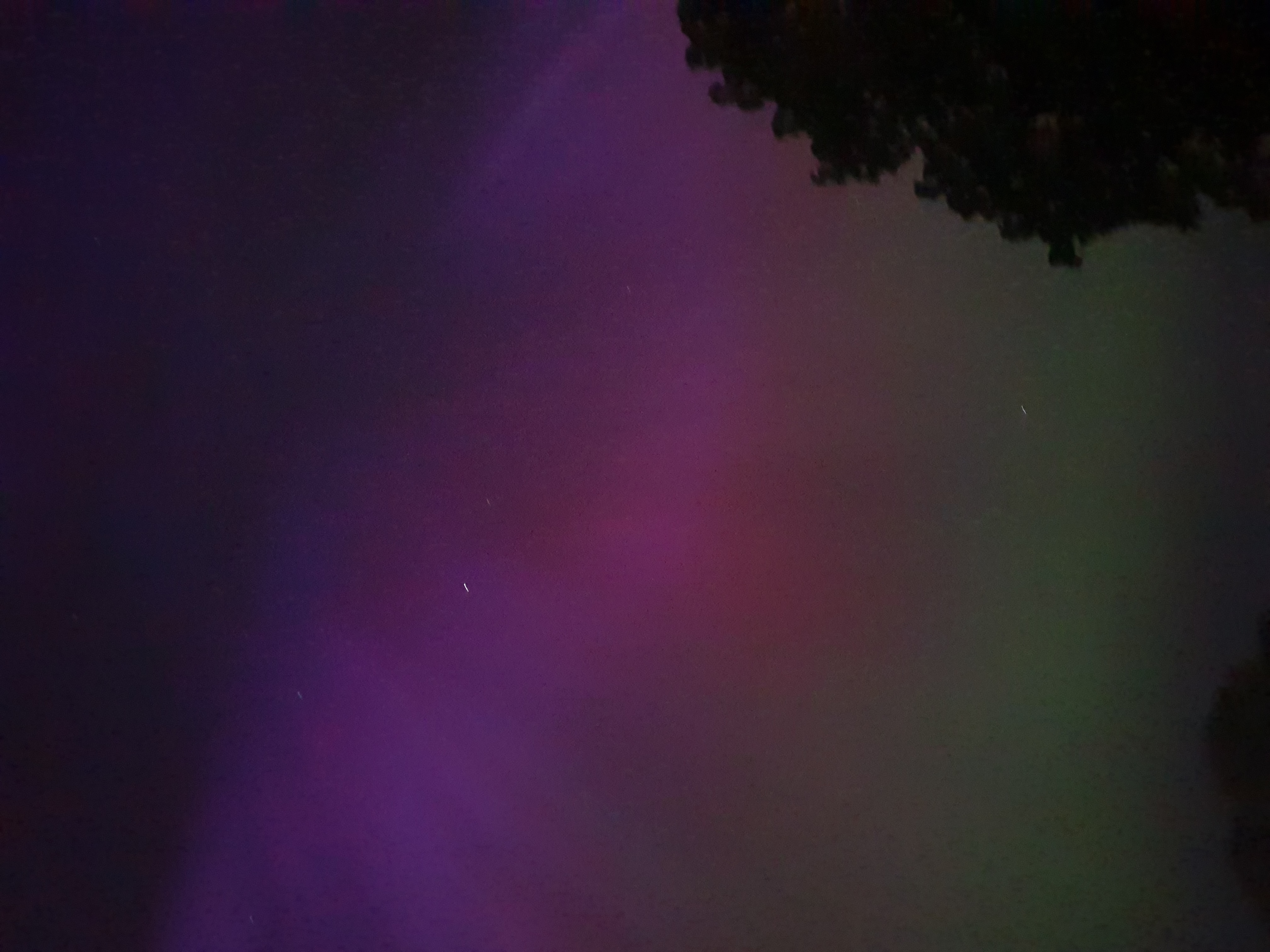 Sky with northern lights of purple, green, pink, and orange hue